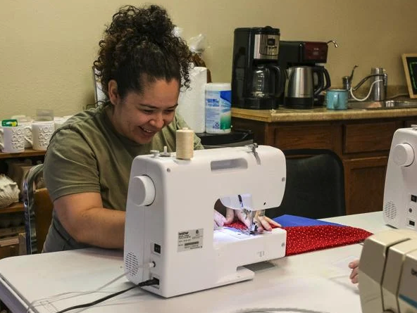 Veteran sewing at machine